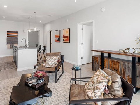 A living room with a brown couch and a coffee table.