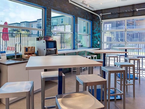 A kitchen with a table and chairs in front of a window.