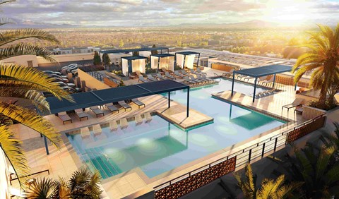 A modern poolside area with a view of the city.