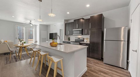 A modern kitchen with a dining table and chairs.