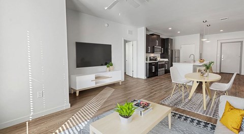 A modern living room with a white sofa and a television.
