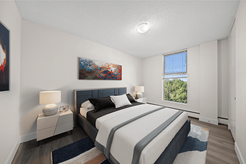 A bedroom with a large bed and a painting on the wall.