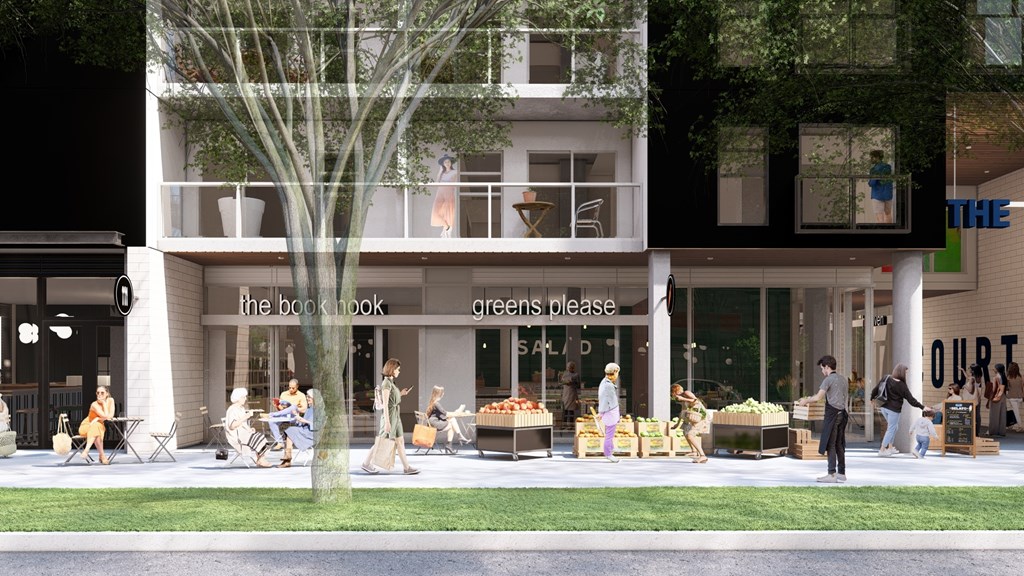 A group of people are standing outside of a building with a green tree in front of it.