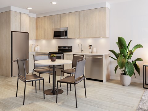 A modern kitchen with a table and chairs.