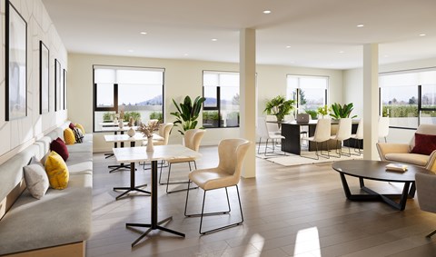 A modern living room with a grey sofa, a white table and chairs, and a view of the outdoors.