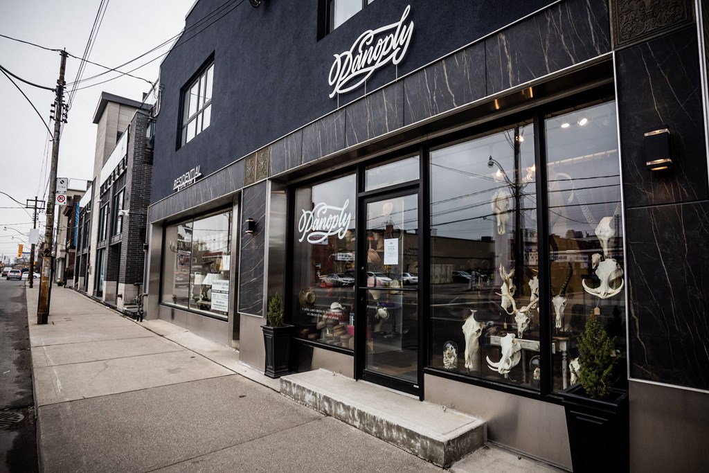 A black building with a white sign that says