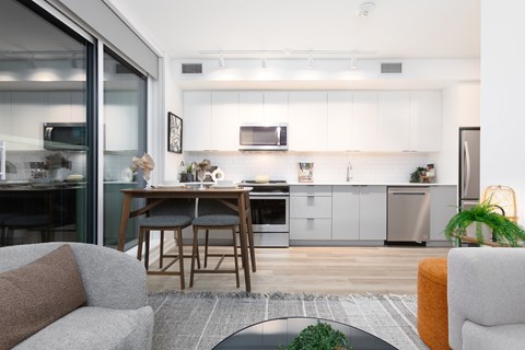 A modern kitchen with a dining table and chairs.