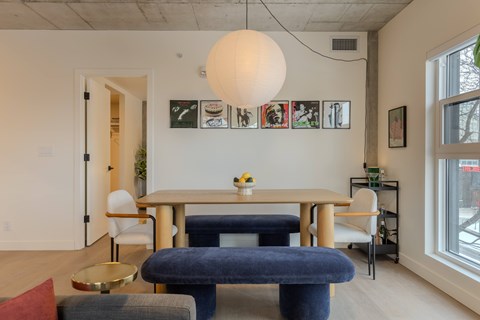 A dining room with a table and chairs.