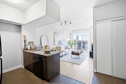 A modern kitchen with a large island and a view of the city.