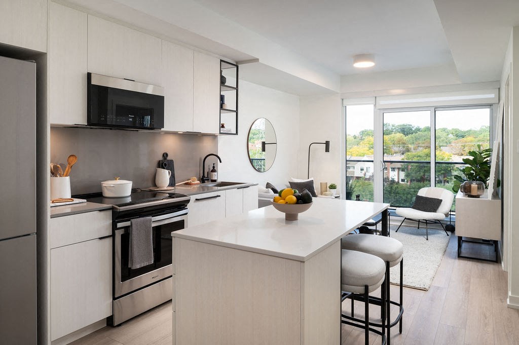A modern kitchen with white cabinets and a large island.
