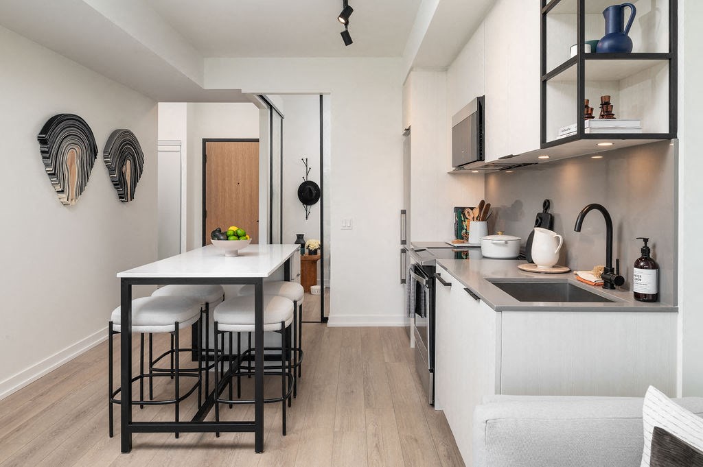 A kitchen with a table and chairs.