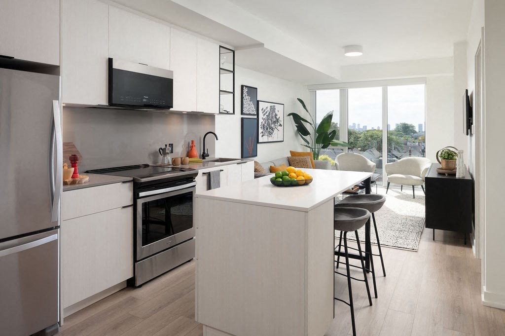 A modern kitchen with a large island and stainless steel appliances.