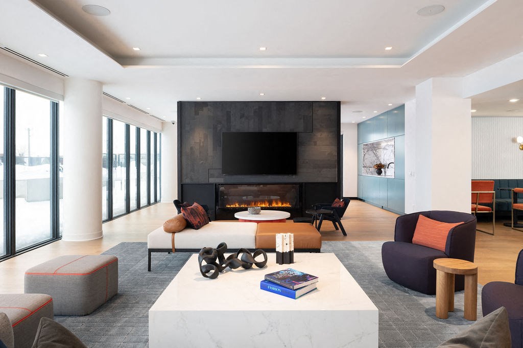 A modern living room with a fireplace and a book on the coffee table.