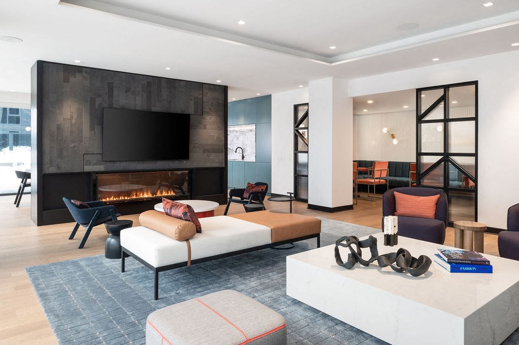 A modern living room with a fireplace and a television.