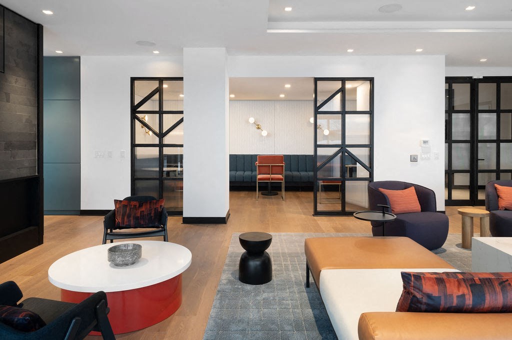 A modern living room with a white and red coffee table.