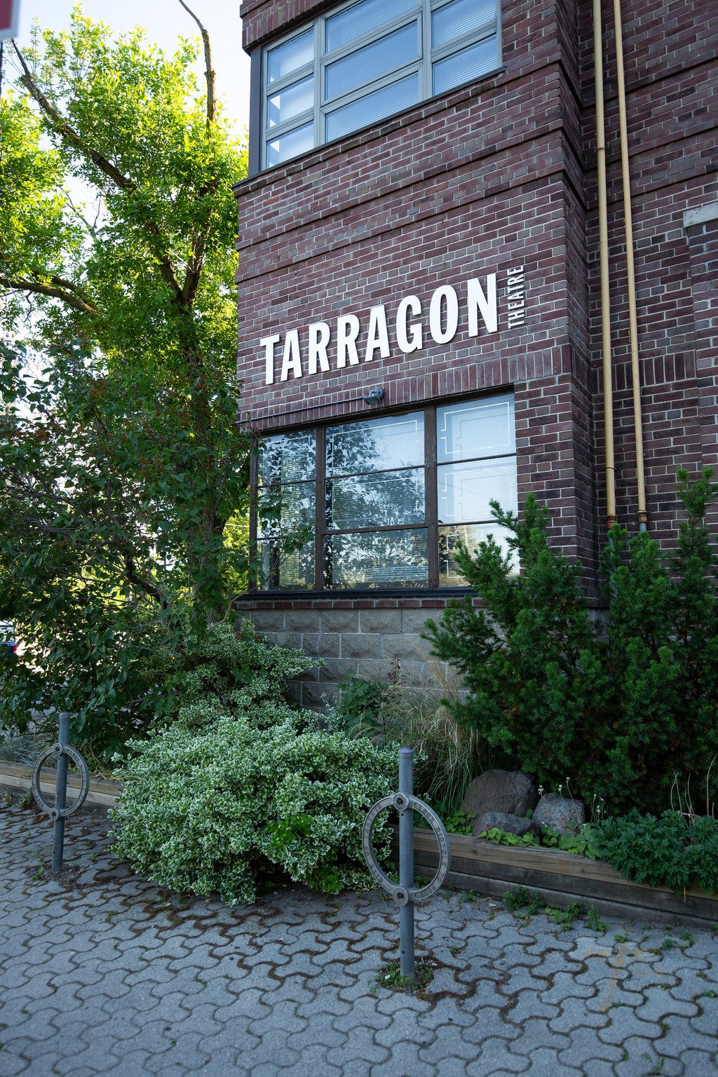 A brick building with a sign that says Tarragon.
