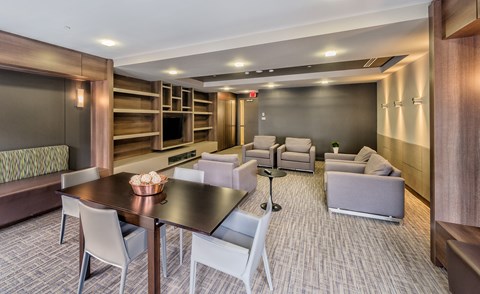A modern dining area with a long table and chairs.