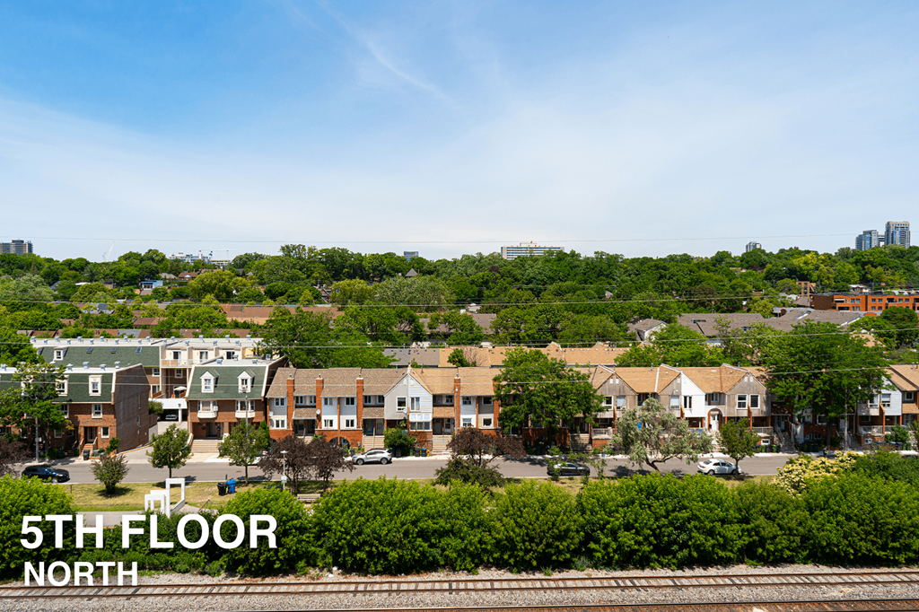 A view of a residential area with houses and greenery.