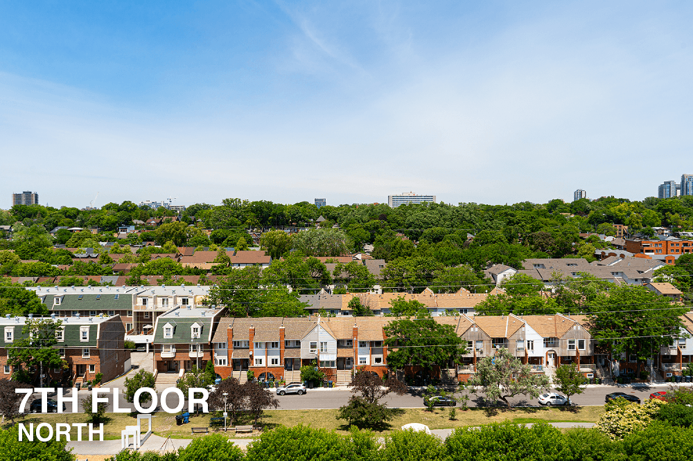 A view of a residential area with houses and trees.
