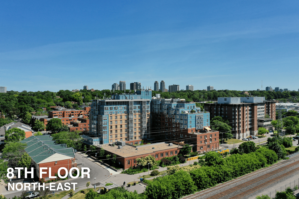 A view of a cityscape with a large building in the center and the text