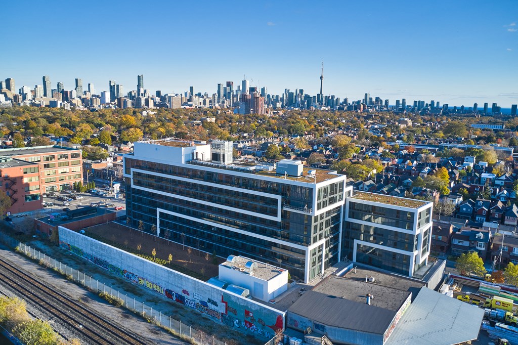 A cityscape with a train track running through the foreground.