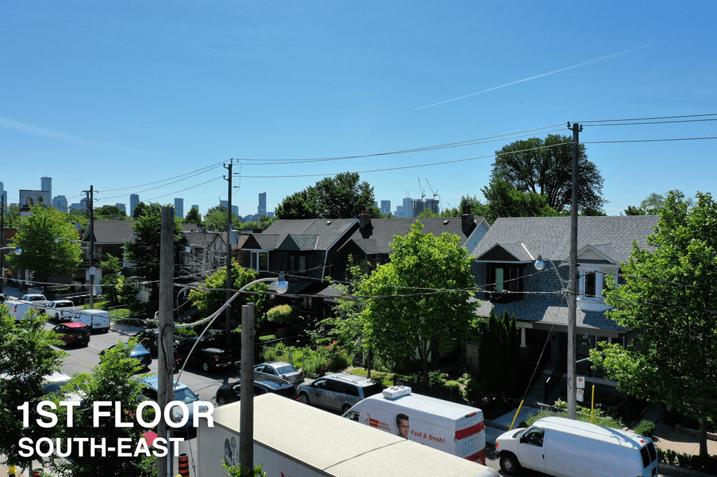 A residential area with houses and parked cars.