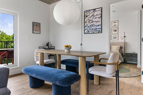 A dining room with a wooden table and chairs.