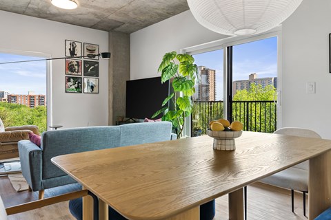 A living room with a blue couch and a wooden table.
