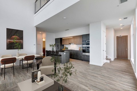A modern kitchen with a dining table and chairs.