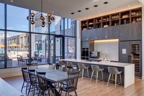 A modern dining area with a long table and chairs.