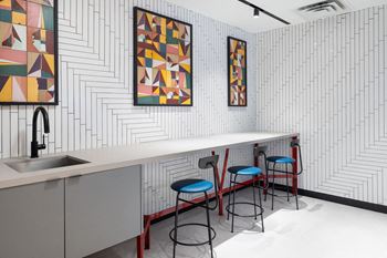 A kitchen with a white counter top and a sink.