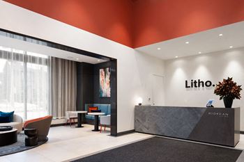 A reception area with a grey reception desk and a sign that says Litho.