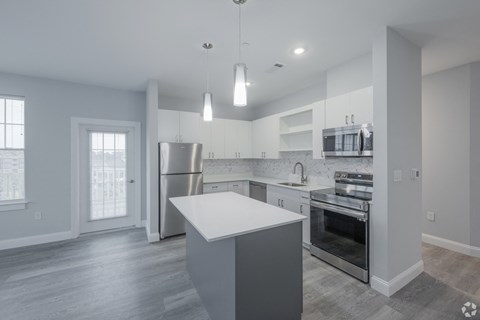 A modern kitchen with a large island in the center.