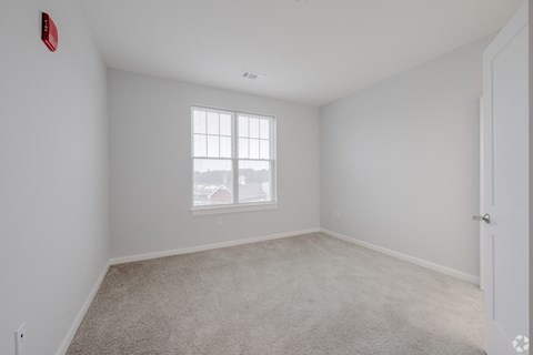 A room with a window and a door.