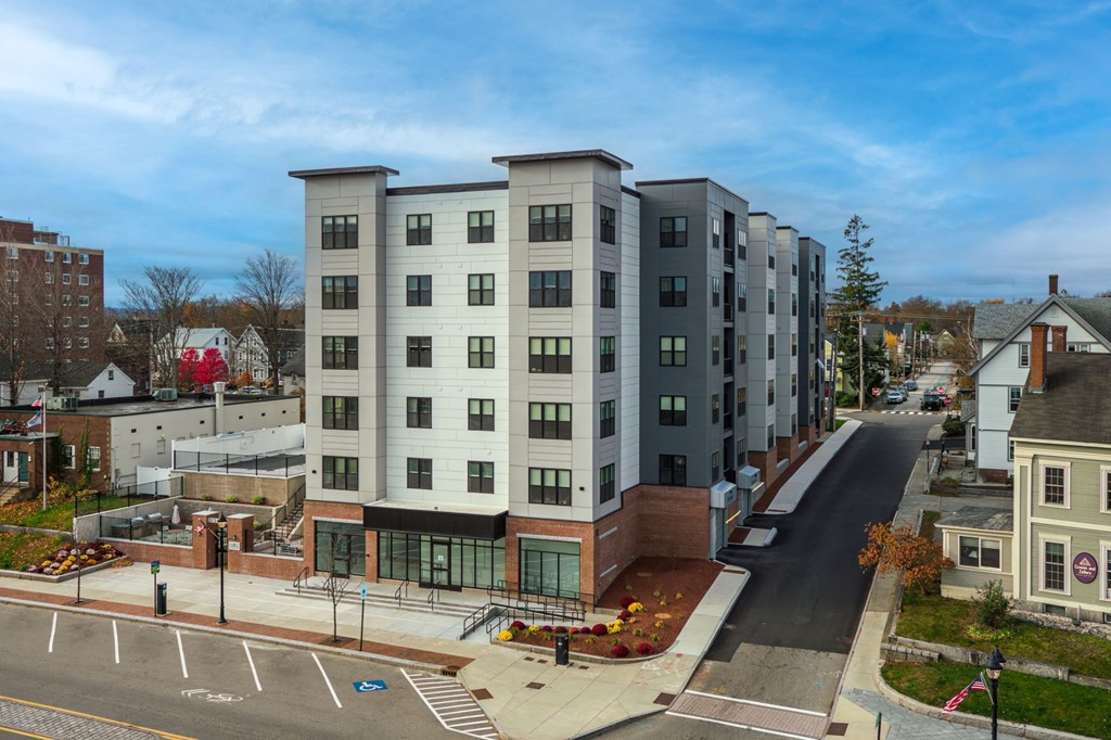 A street view of a residential area with apartment buildings.