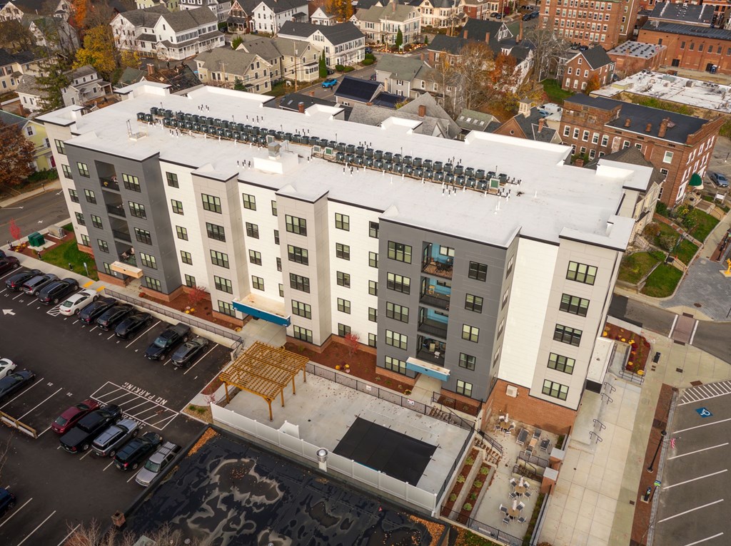 A large building with a parking lot in front of it.