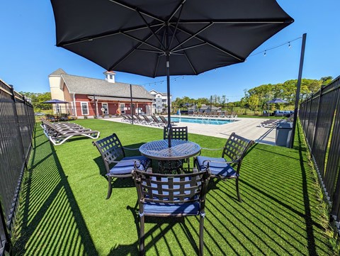 a patio with a table and chairs and an umbrella