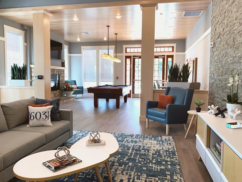 A living room with a grey couch and a blue chair.