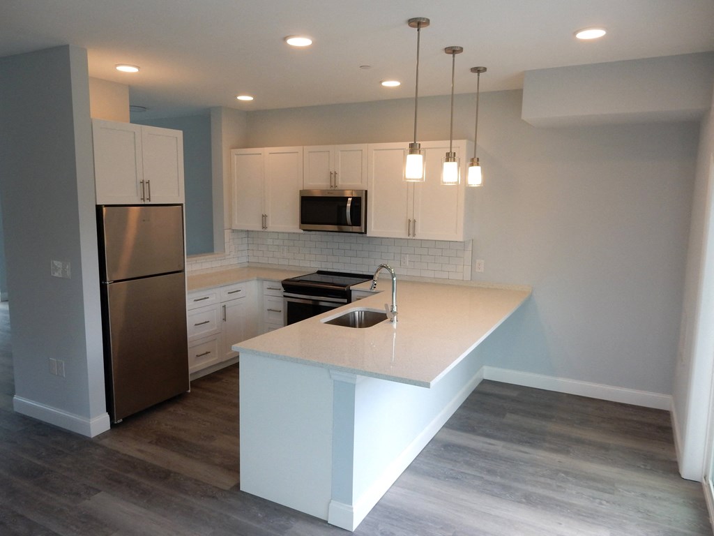 a kitchen with white cabinets and a white counter top