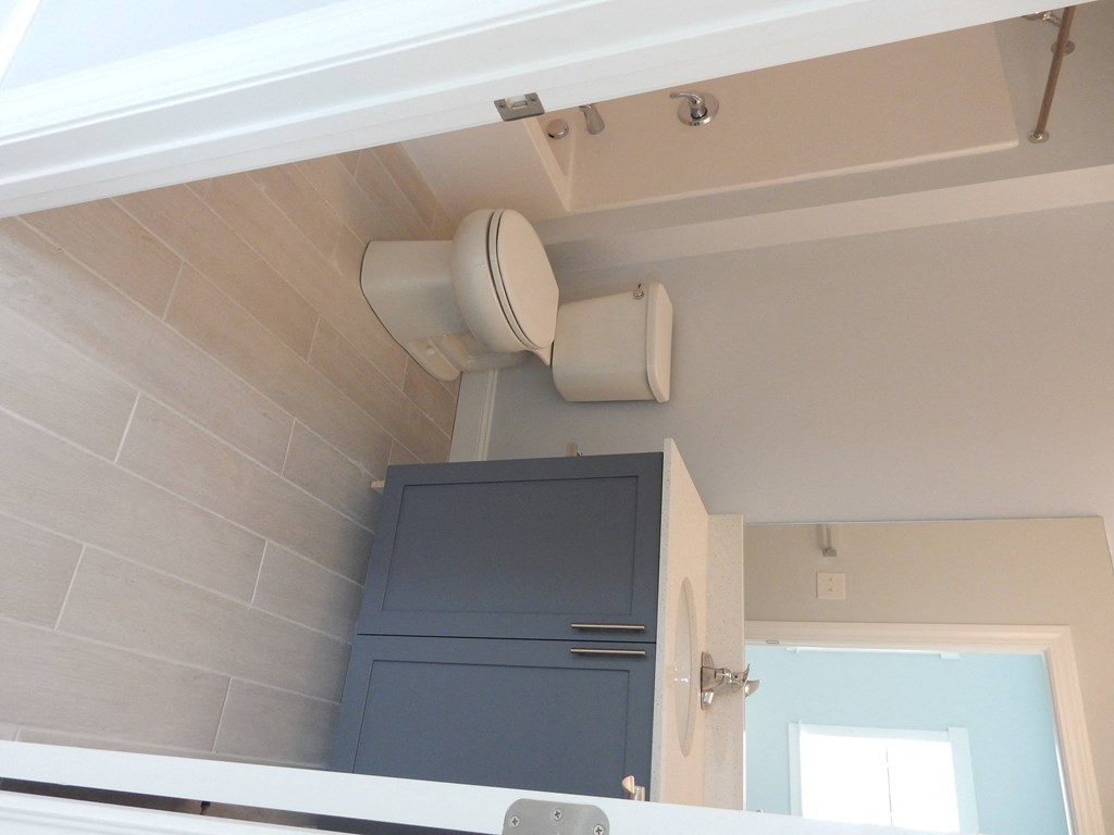 a view of a bathroom with a toilet and a mirror