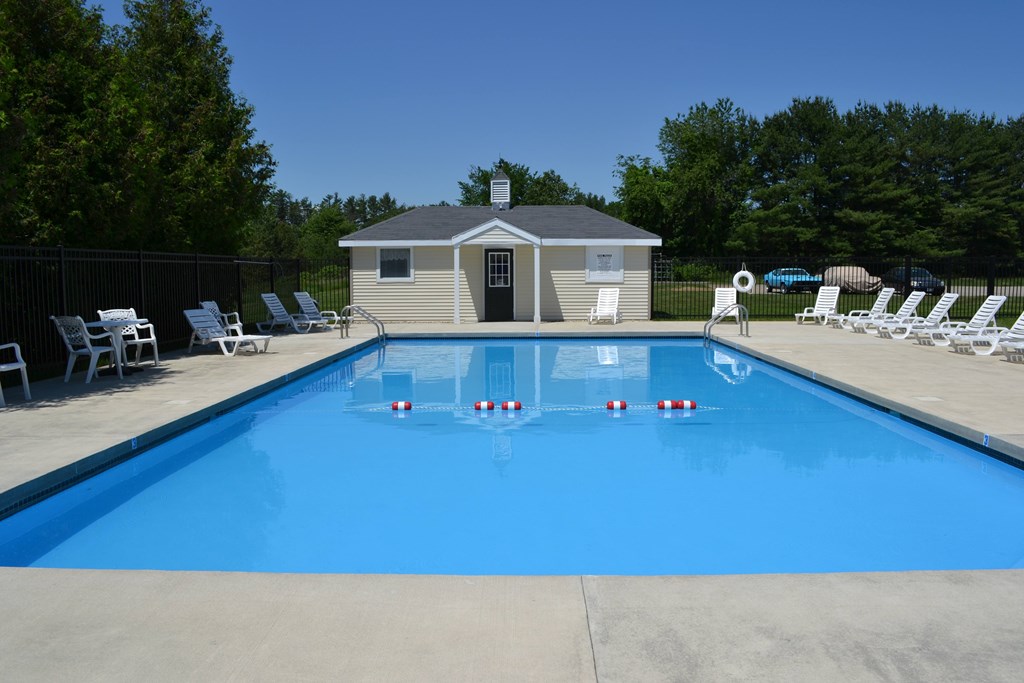 A pool with a small building next to it.