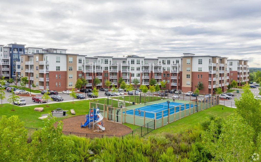 an image of an apartment building with a playground