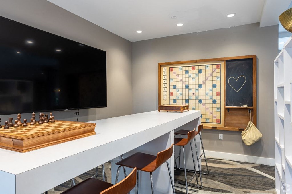a game room with a chess board and a long white table