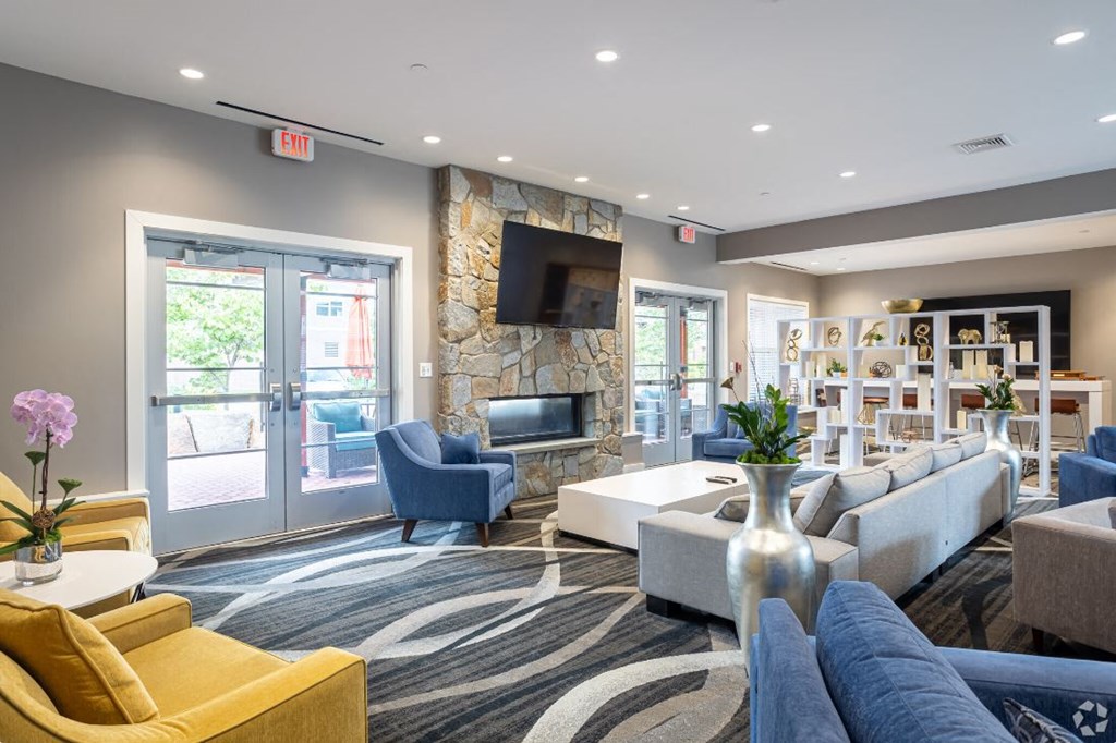 a living room with couches and chairs and a television