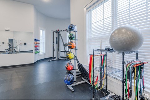 a workout room with an exercise ball and other equipment