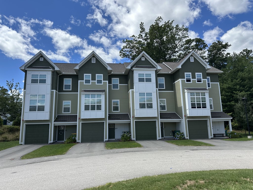 A large, modern house with a grey and white exterior.