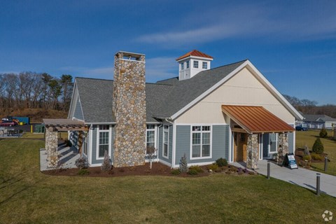 a house with a stone chimney on the side of it