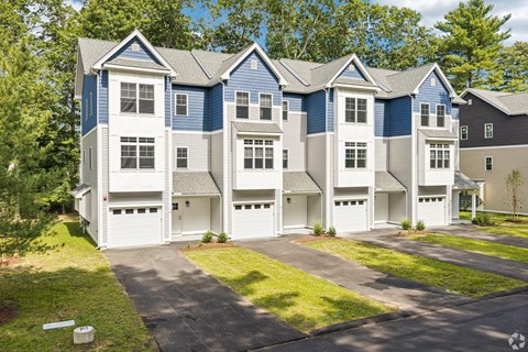 A row of townhouses with garages in front.