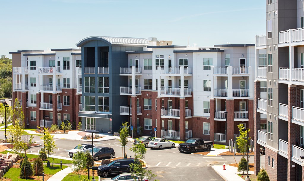 an aerial view of an apartment complex with cars parked in a parking lot