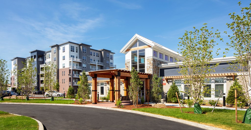 an exterior view of a building with trees and a road